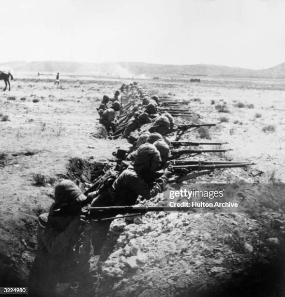 Lineup of British troops aim their rifles in the Orange River trenches during the Boer War, South Africa.