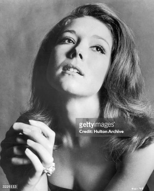 Studio portrait of British actor Diana Rigg, clasping her hands and looking up. She was appearing in director Peter Hunt's film, 'On Her Majesty's...