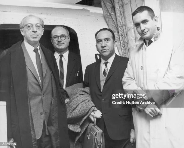 American composer Aaron Copland , historian Richard Morse, Chilean poet Fernando Algeria and American playwright Edward Albee pose as they disembark...