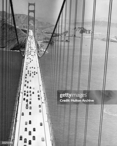 High-angle view of traffic and pedestrians using the Golden Gate Bridge, San Francisco, California, circa 1937.