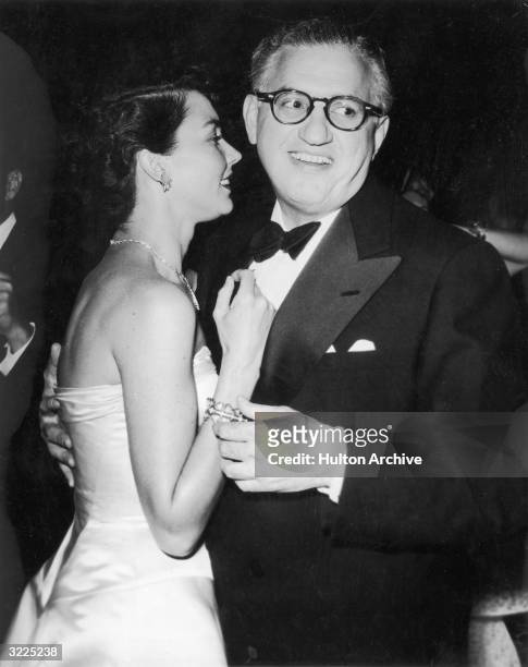 Producer David O. Selznick smiles while dancing with actor Jennifer Jones at the Beverly Hills Hotel in California. Selznick and Jones married in...
