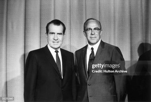 President-elect Richard M Nixon standing with his newly named Secretary of Labor George P Shultz after announcing his cabinet appointment,...