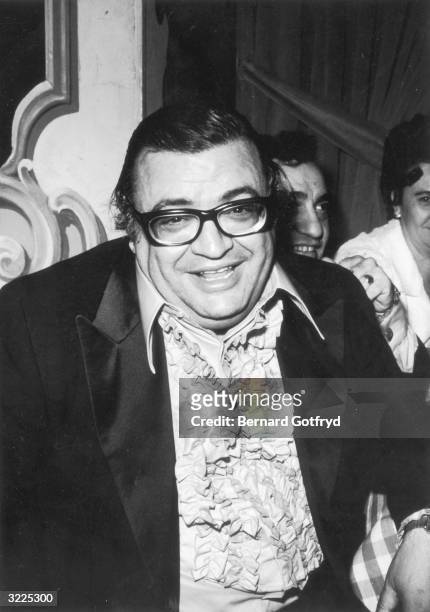 American author Mario Puzo smiles while sitting at a party in New York for director Francis Ford Coppola's film, 'The Godfather'. Puzo adapted his...