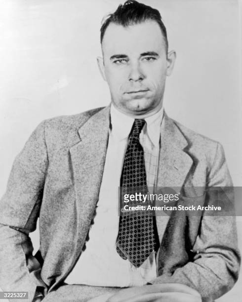 Portrait of American criminal gang leader and bank robber John Dillinger wearing a jacket and tie.