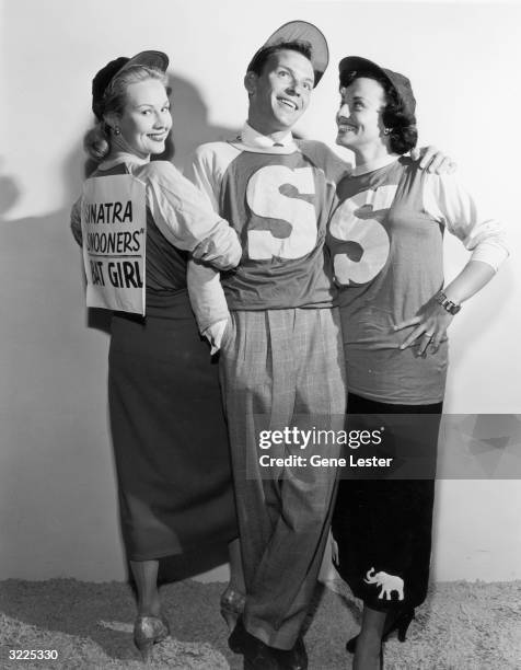 American pop singer and actor Frank Sinatra poses with American actors Virginia Mayo and Kay Starr in a promotional portrait for a charity baseball...