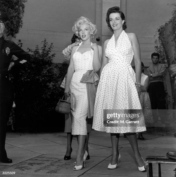 American actresses Marilyn Monroe and Jane Russell stand in the courtyard of Grauman's Chinese Theater as they promote director Howard Hawks's film,...