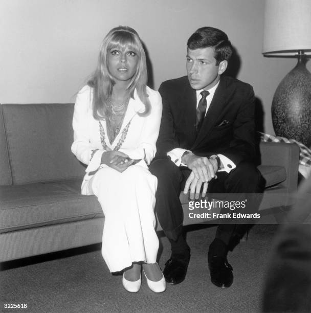 American singers, siblings Nancy and Frank Sinatra Jr, sit on a sofa backstage at the Frank Sinatra Musical Performance Awards, Royce Hall...