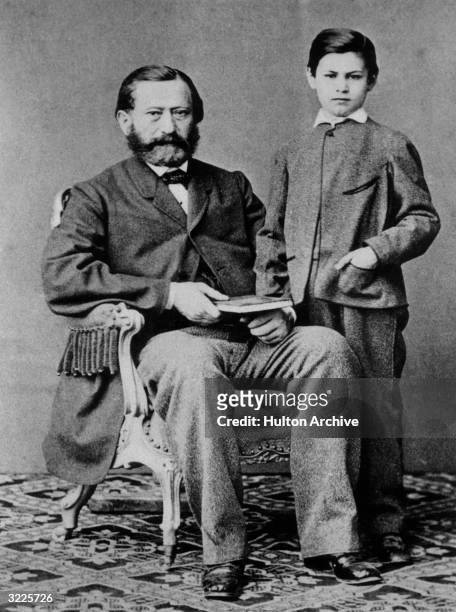 Studio portrait of Austrian psychoanalyst Dr. Sigmund Freud as a child, standing next to his father.