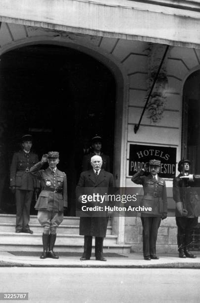 French general Charles Huntziger , French Marshal Henri-Philippe Petain , chief of state of the Vichy regime, and general Auguste Laure review a...