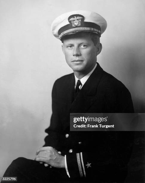 Portrait of John F Kennedy, future US senator and president, wearing his U.S. Navy uniform and posing with his hands in his lap, World War II , circa...