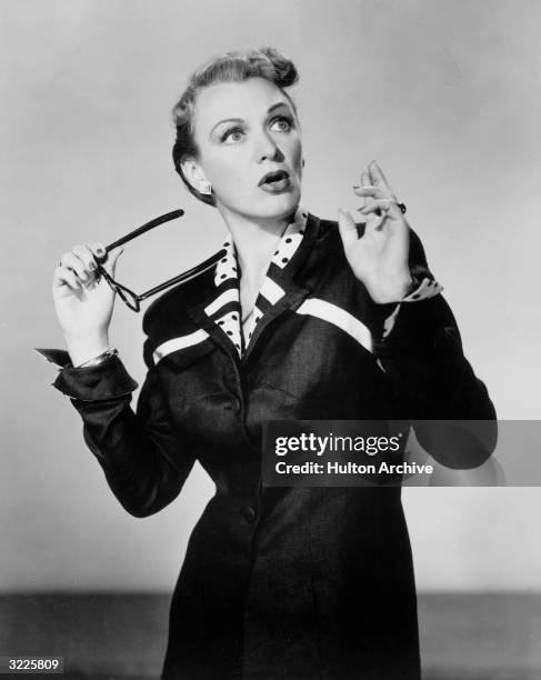 American actor Eve Arden holding a pair of glasses and expressing shock in a promotional portrait for the television show, 'Our Miss Brooks,' in...