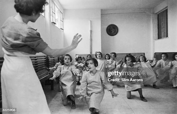 Group of girls in a dance activity class at a convent in Rome, where they are cared for by nuns. They are part of a group of children, who were...