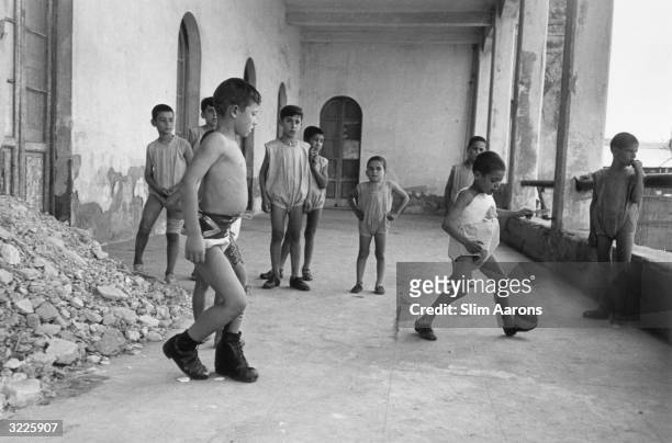 Young boys play football at a convent in Rome, where they are cared for by nuns. They are part of a group of children, who were abandoned or orphaned...