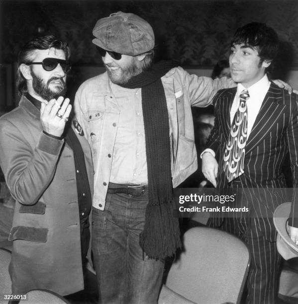 British drummer Ringo Starr , formerly of The Beatles, gestures in conversation with American singer Harry Nilsson and English drummer Keith Moon of...