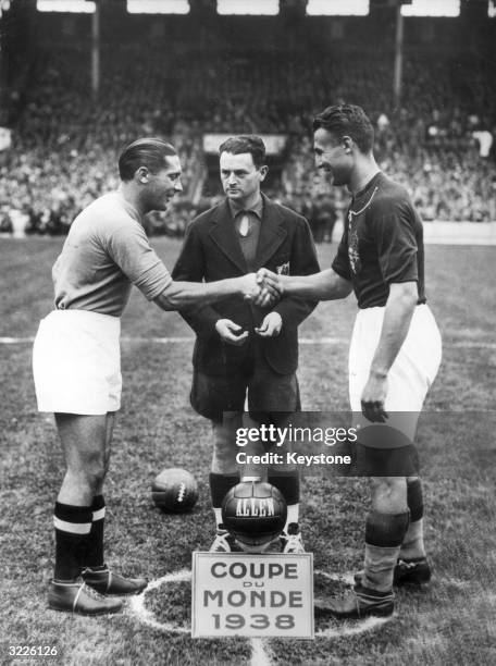 Italian captain Giuseppe Meazza shakes hands with Hungarian captain Gyorgy Sarosi, at the start of the FIFA World Cup final in Paris. Italy beat...
