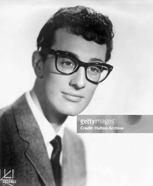 Headshot of American rock 'n' roll musician and singer Buddy Holly wearing his signature horn-rimmed eyeglasses.