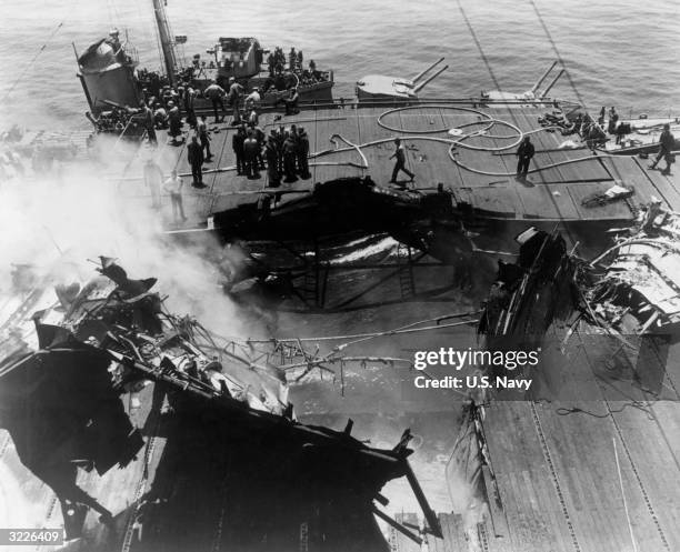 Overhead view of the gaping hole in the deck of the USS 'Bunker Hill' after it was dive-bombed by two Japanese Kamikaze planes off the shores of...