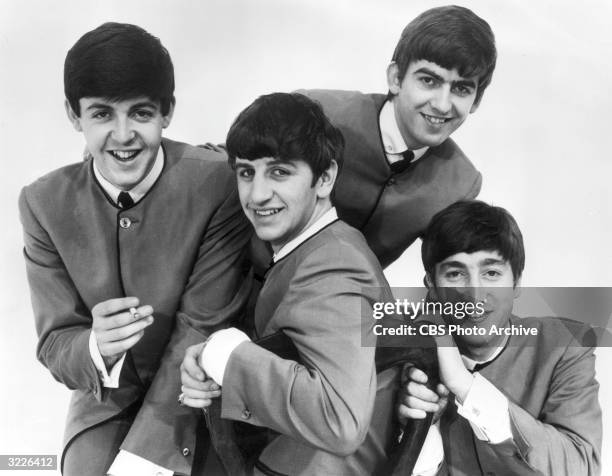 Promotional portrait of the British rock band The Beatles, circa 1963. Paul McCartney holds a cigarette, others are Ringo Starr, George Harrison and...