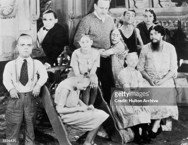 American director Tod Browning posing on set with the cast of his circus film, 'Freaks'. Amongst the cast members are Josephine Joseph, Johnny Eck,...