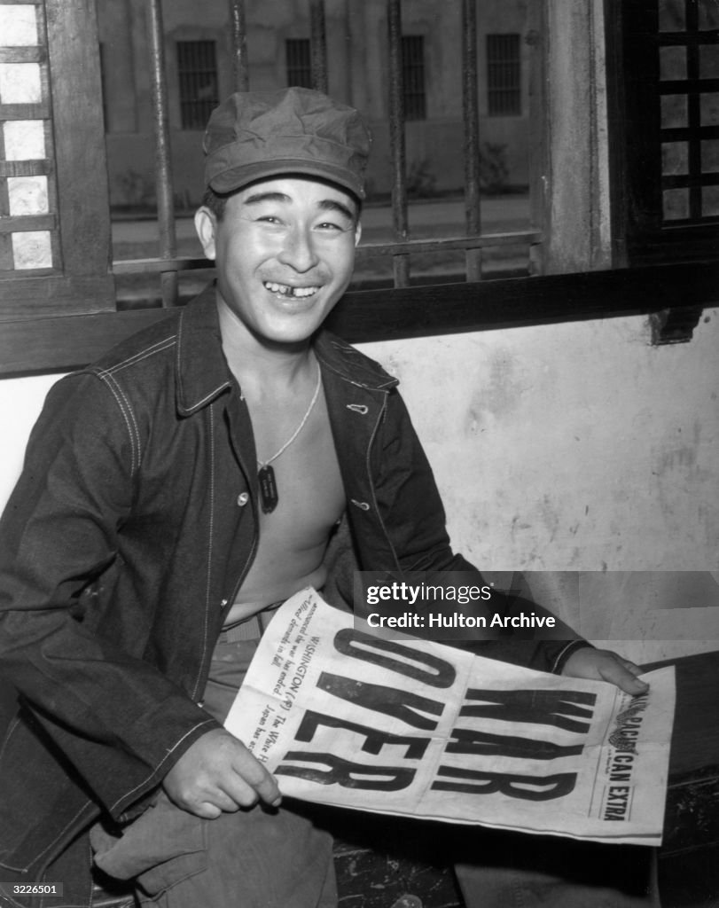 Japanese Pow Color Japanese POW smiling while holding a 'Daily Pacifican' newspaper ...