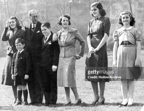 Full-length image of Joseph P Kennedy with his daughter Kathleen, sons Teddy and Robert, wife Rose, and daughters Patricia and Jean, London, England.
