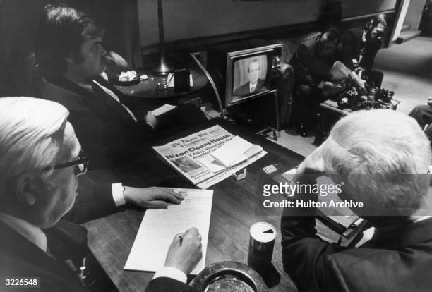 White House reporters watch President Richard Nixon on TV as he told the nation of White House involvement in the Watergate scandal, Washington D.C.
