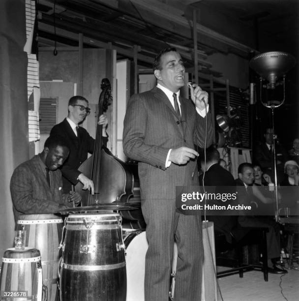 American singer Tony Bennett performs on stage with American jazz drummer Art Blakey.