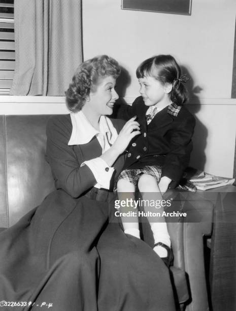 American actor and comedian Lucille Ball faces her young niece on the set of director Lloyd Bacon's film 'Miss Grant Takes Richmond'.