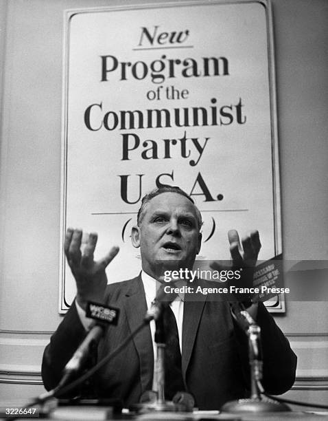 American Communist Party leader Gus Hall sits and speaks at a press conference announcing the Party's platform to be ratified at their New York City...