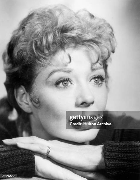 American actor, singer and dancer Gwen Verdon stares wide-eyed while leaning on her hands in a promotional headshot portrait for Bob Fosse's Broadway...