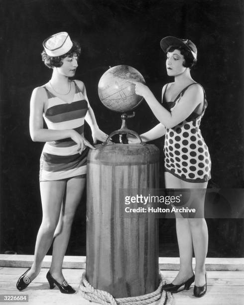 Full-length promotional image of two women wearing swimsuits, standing on opposite sides of a globe, and pointing to Mexico, in a Mack Sennett...