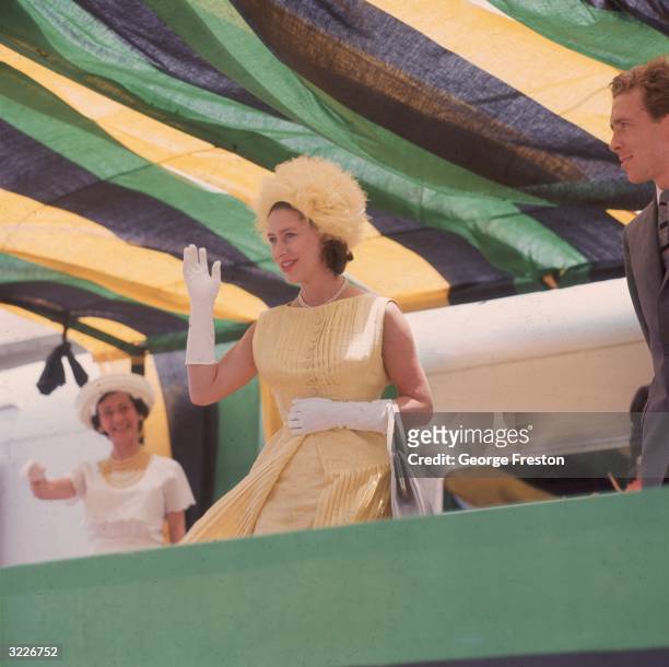 Princess Margaret waving to crowds during a dance display at Williamsfield in Jamaica . The royal couple are visiting the island to attend the...