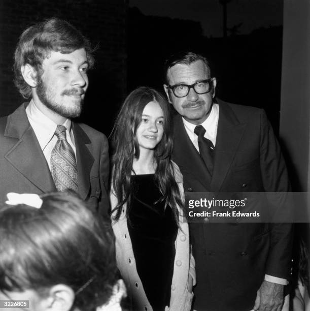 American actor Walter Matthau leans forward while posing with his children, David and Jenny, at a screening of director Blake Edwards's film,...