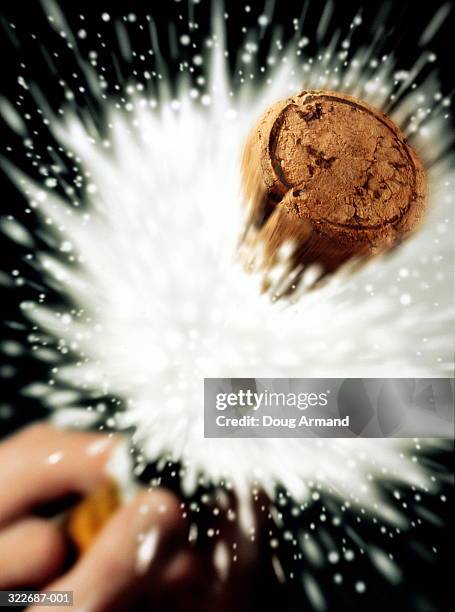 champagne cork flying from bottle   (digital composite) - kork stock-fotos und bilder