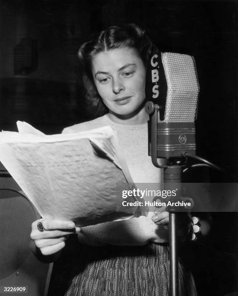 Portrait of Swedish-born actor Ingrid Bergman standing in front of a CBS microphone and reading from American dramatist Eugene O'Neill's play, 'Anna...