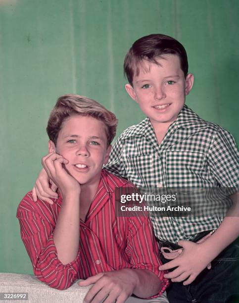 American actors Tony Dow and Jerry Mathers pose together in a promotional portrait for the television show, 'Leave It to Beaver'.
