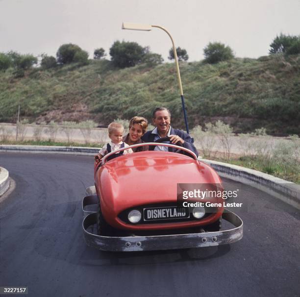 Walt Disney drives a red bumper car with his daughter and grandson as passengers at Disneyland theme park, Anaheim, California.