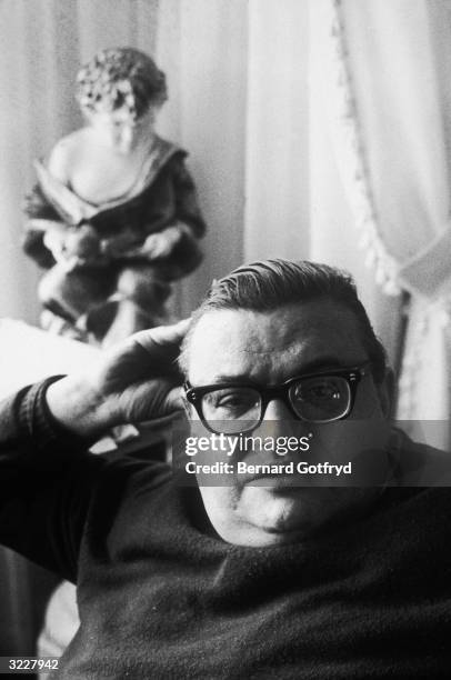 Headshot portrait of American writer Mario Puzo , author of the novel The Godfather, sitting on a sofa.