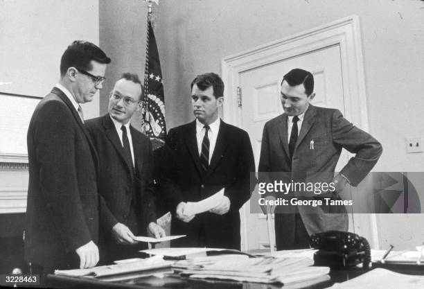 Attorney General Robert Kennedy speaks with Theodore Sorensen, McGeorge Bundy and Kenneth O'Donnell outside President John F Kennedy's office,...