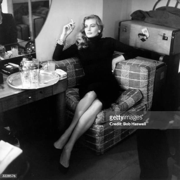 Swedish actress Anita Ekberg relaxes with a cigarette in London.