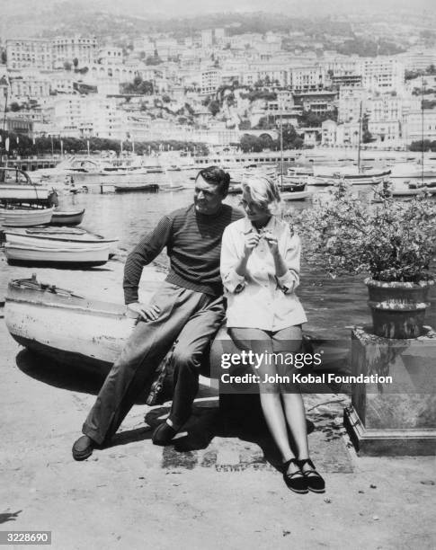 Cary Grant and Grace Kelly pose on the French Riviera during the filming of the Alfred Hitchcock thriller 'To Catch A Thief'. In the film, Grant...