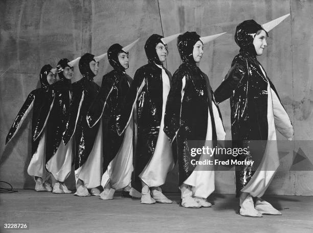 Group of children from the Actors' Orphanage in penguin costumes rehearse their role for a children's pantomime production of 'Robinson Crusoe' at...