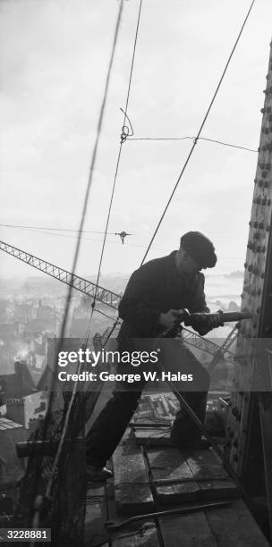 Riveter carrying out repairs to the Blackpool Tower in preparation for the coming holiday season.