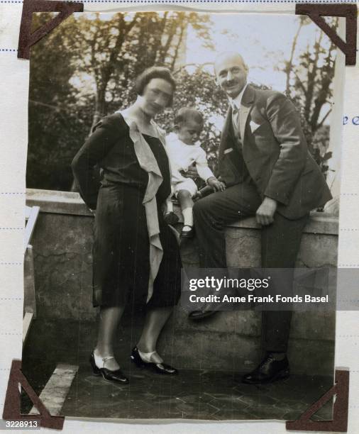 Mrs Edith Frank and Mr Otto Frank, the parents of Anne Frank, with their firstborn daughter, Margot, from Margot's photo album, Aachen, Germany.