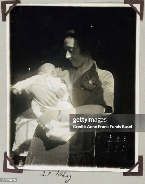 Edith Frank holds her baby daughter, Margot, Anne Frank's older sister, in a patch of sunlight, Frankfurt am Main, Germany. Taken from the photo...