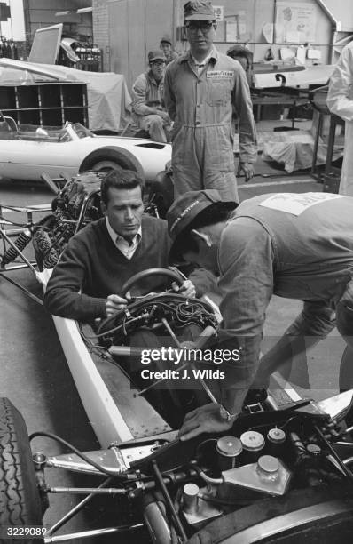 American actor James Garner at the wheel of a racing car during the filming of John Frankenheimer's 'Grand Prix' on location at the Cooper Car...