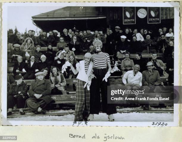 Portrait of Bernd Elias, the cousin of Anne Frank and another boy as a clowns on ice skates in front of an audience taken from Anne Frank's photo...