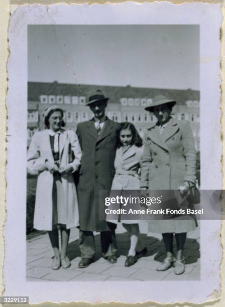 Full-length family portrait of Margot, Otto, Anne , and Edith Frank at the Merwedeplein, taken from Anne's photo album, Amsterdam, Holland, 1941.