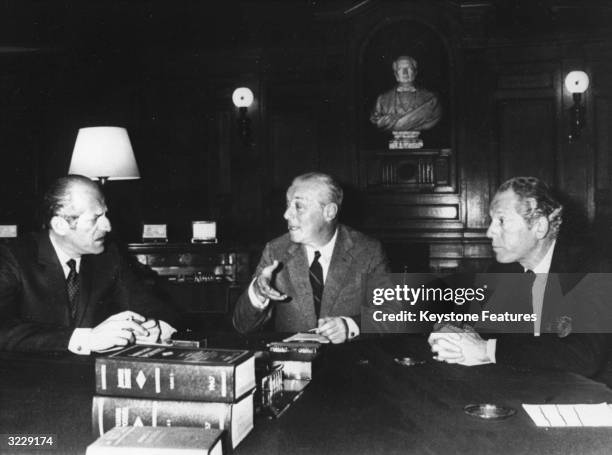 Merchant bankers, the Rothschilds in an office at their headquarters in the Rue Laffitte, Paris. Left to right : Baron Elie De Rothschild, Baron Guy...