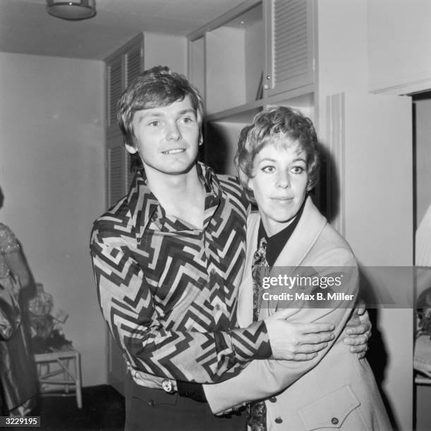 American fashion designer Bob Mackie embraces actor and comedian Carol Burnett at one of his fashion shows. Mackie designed the costumes for 'The...